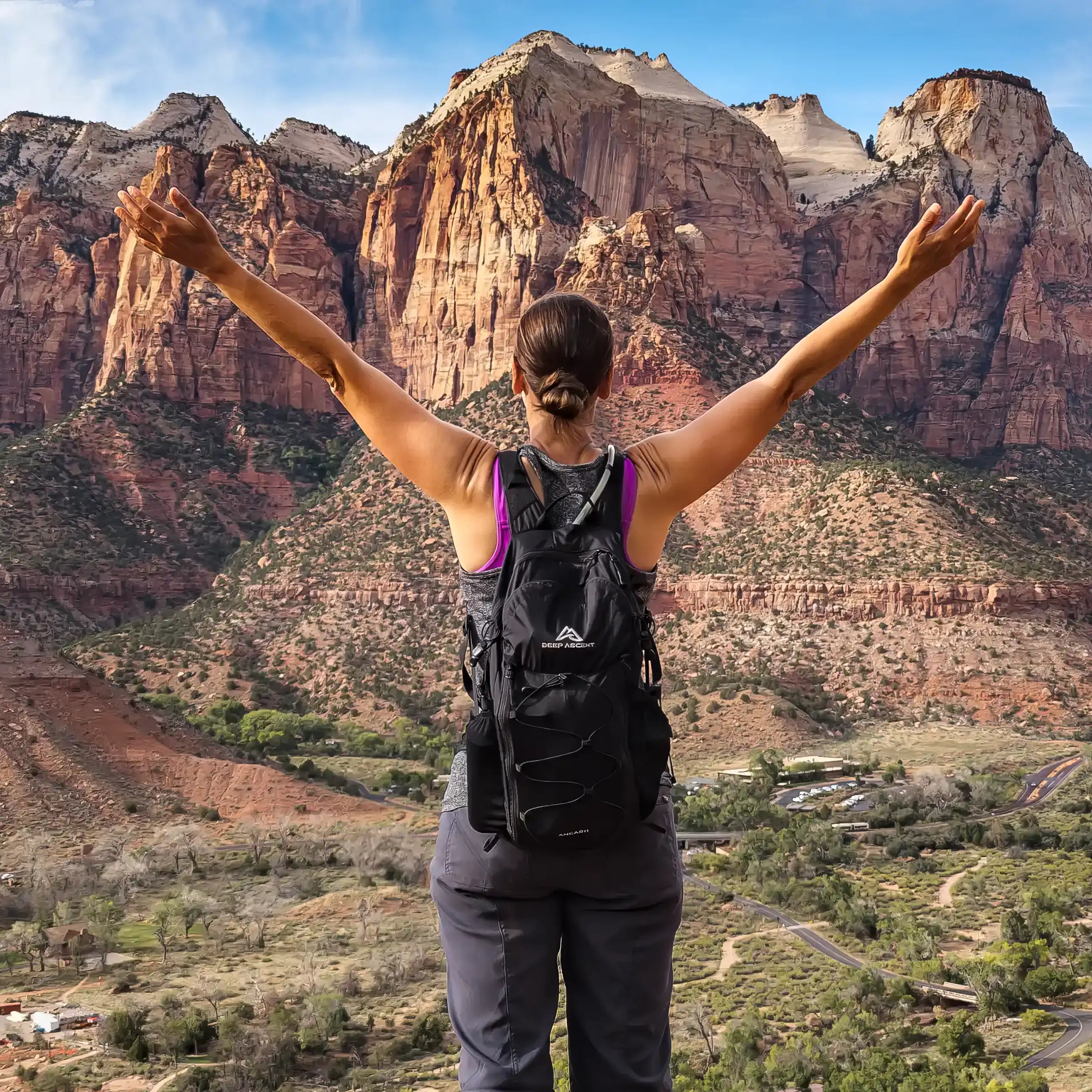 Hiker wearing the Ancash Packable Daypack overlooking Zion National Park from the top of Watchman Trail with arms outstretched.