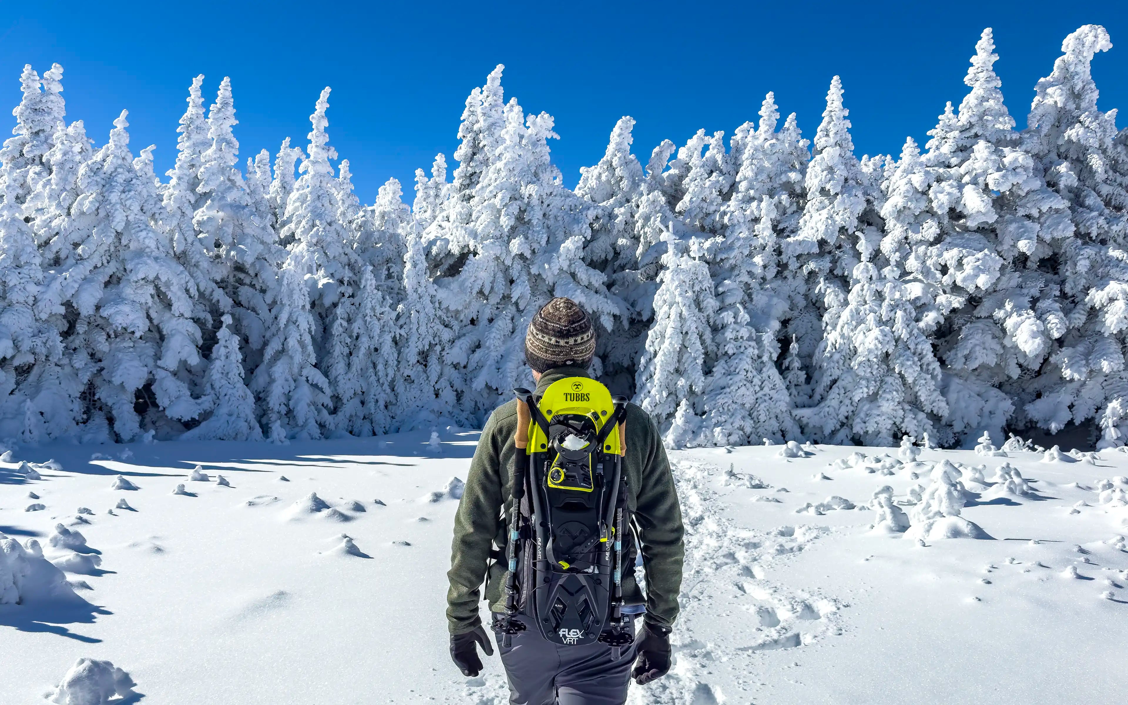 Packable hiking backpack with gear attachments for hiking poles and snowshoes.