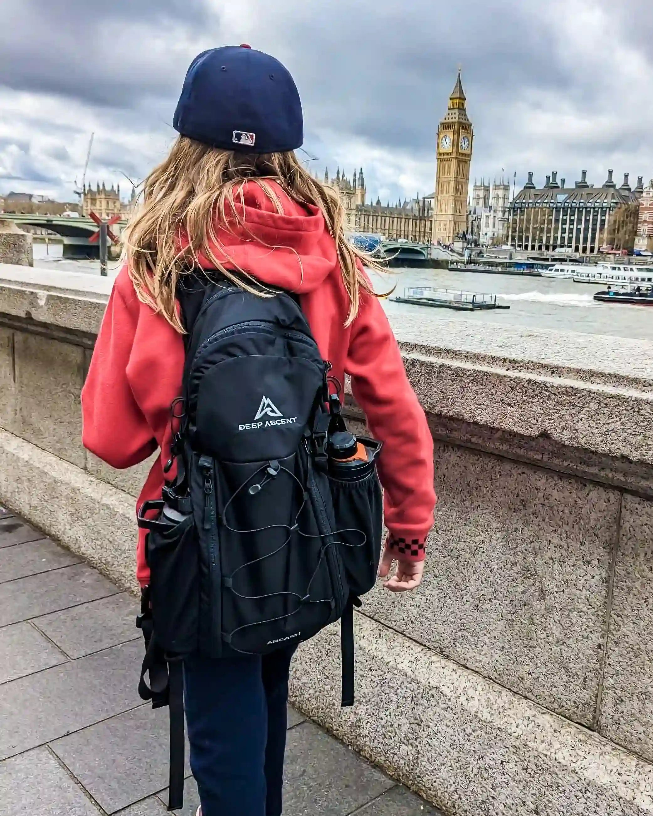 Person walking in London with Big Ben in the background, wearing the Ancash Packable Daypack by Deep Ascent.