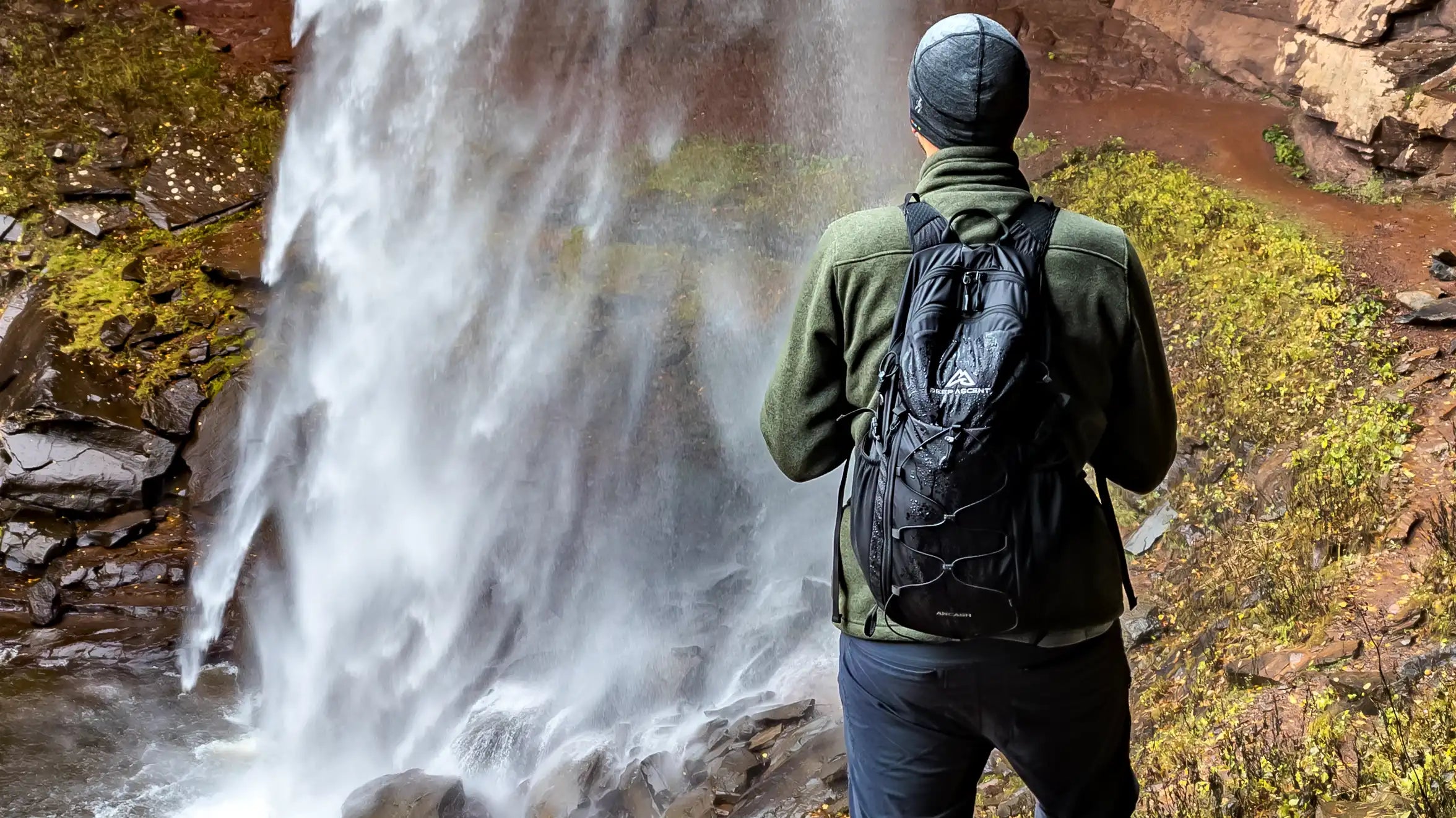 Hiker wearing the Ancash Packable Daypack standing in front of Kaaterskill Falls in New York.