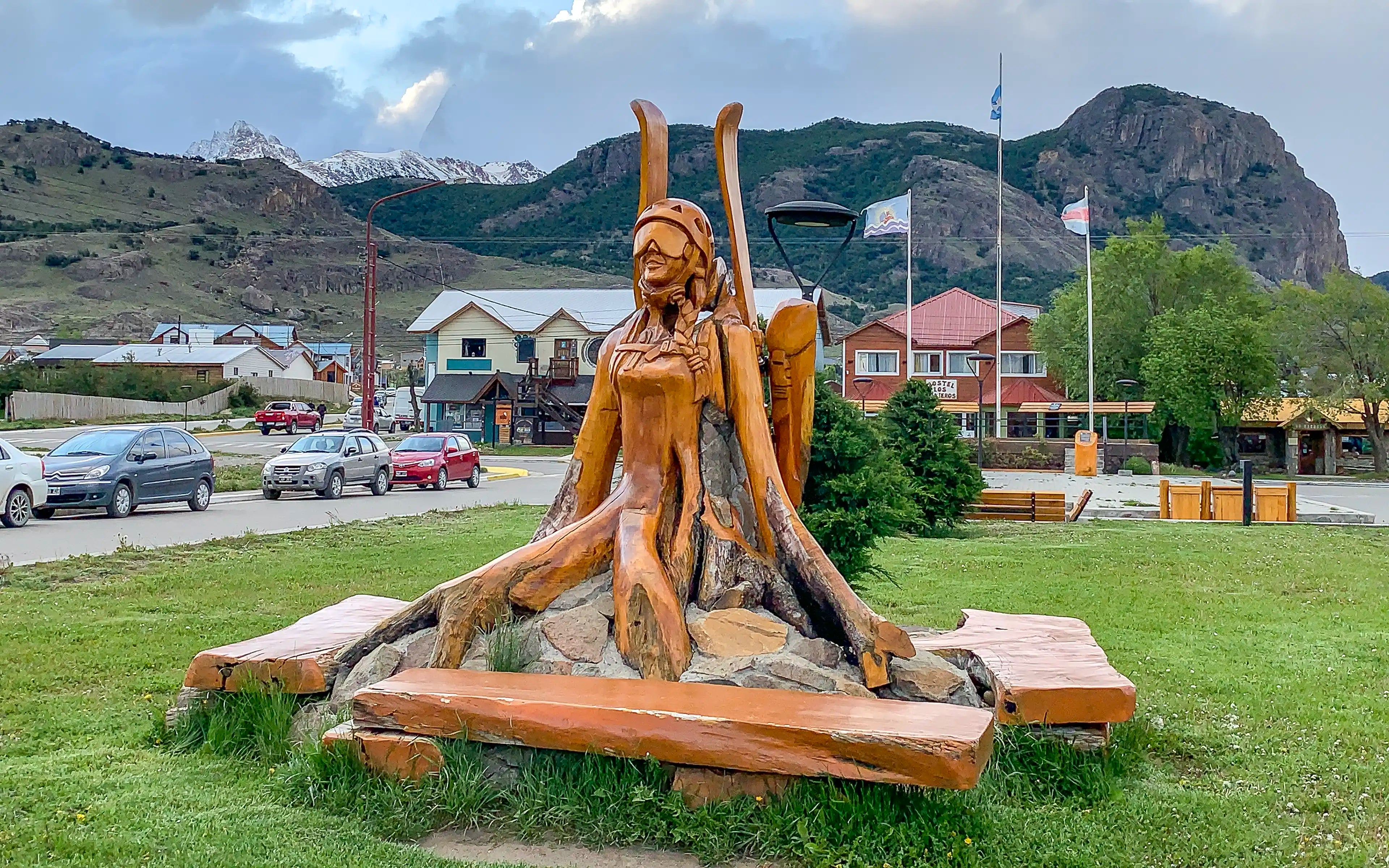 A wooden park bench sculpture of a skier in El Chaltén, Argentina.