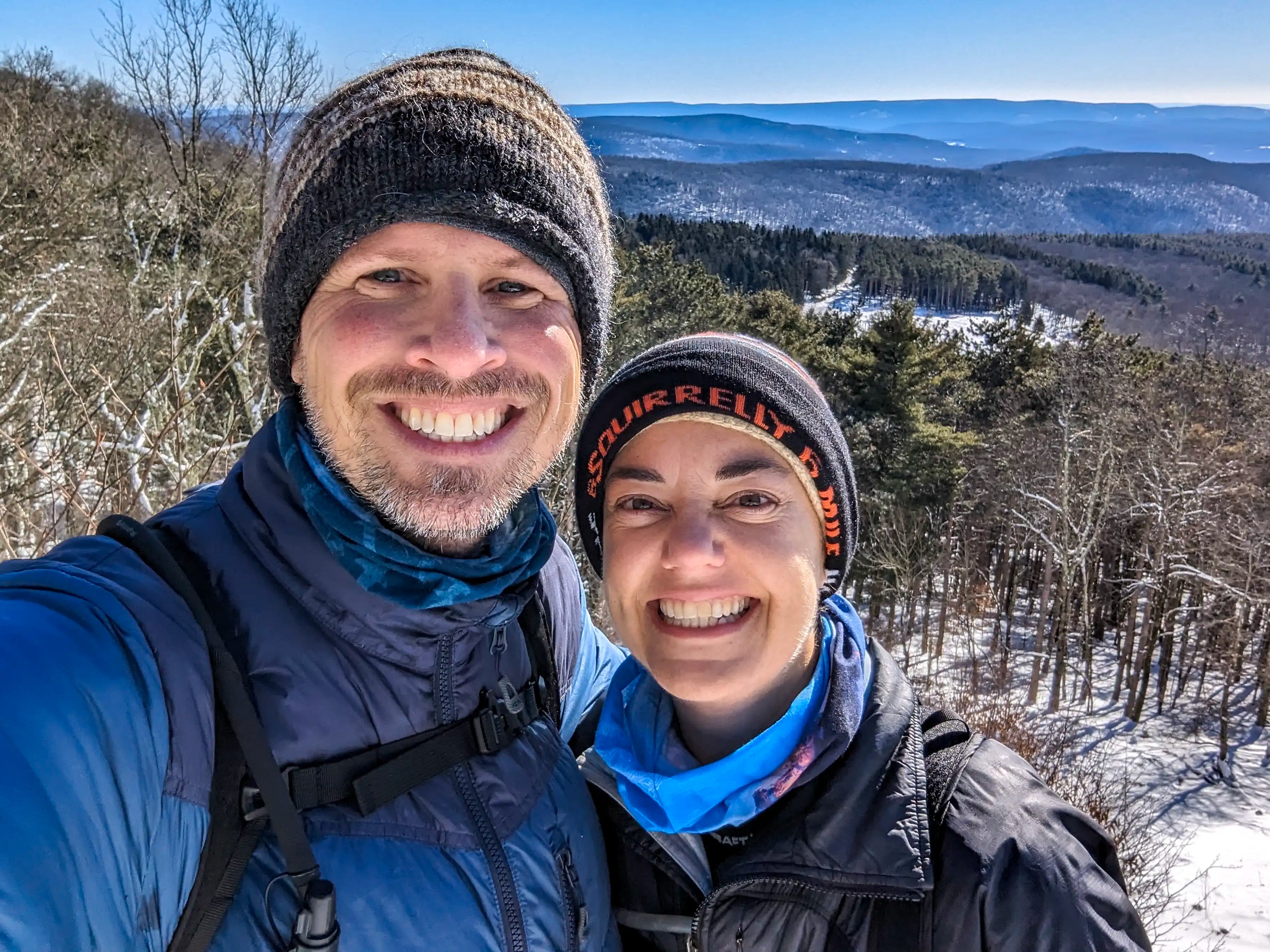 A male and female hiker on Red Hill Mountain in New York wearing the Ancash Packable Daypack by Deep Ascent.